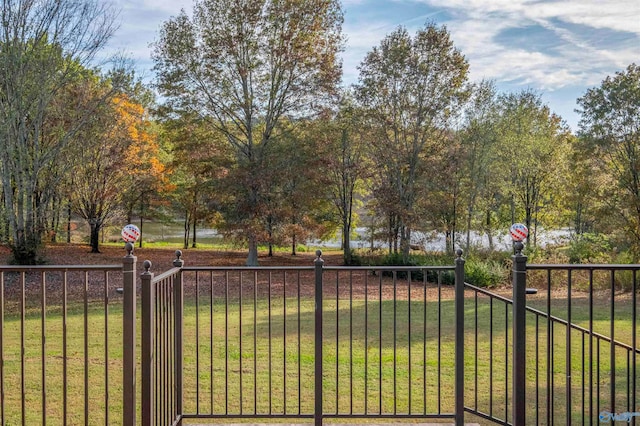 view of gate featuring a yard