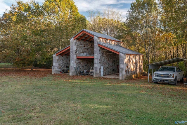 view of outdoor structure with a lawn and a carport