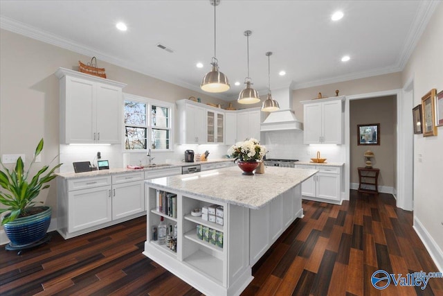 kitchen with dark hardwood / wood-style flooring, a center island, white cabinetry, and light stone counters