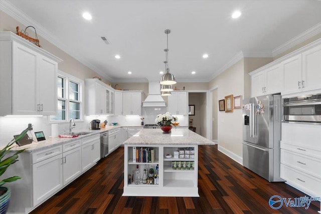 kitchen with white cabinetry, dark wood-type flooring, a center island, and stainless steel appliances