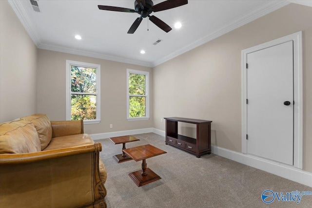 sitting room featuring light colored carpet, ceiling fan, and crown molding