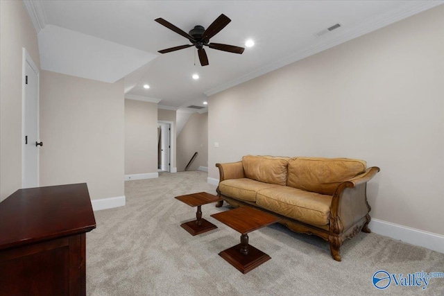 living room with ceiling fan, ornamental molding, and light carpet