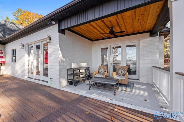 wooden deck featuring ceiling fan and french doors