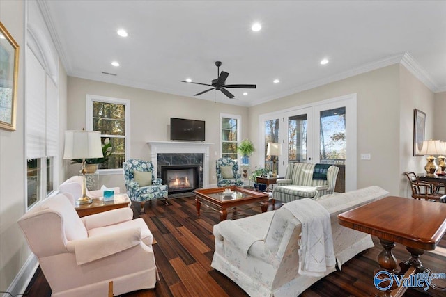 living room with ceiling fan, a fireplace, dark hardwood / wood-style floors, and ornamental molding