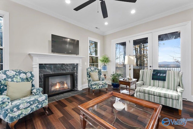 living room with ceiling fan, dark hardwood / wood-style flooring, and ornamental molding