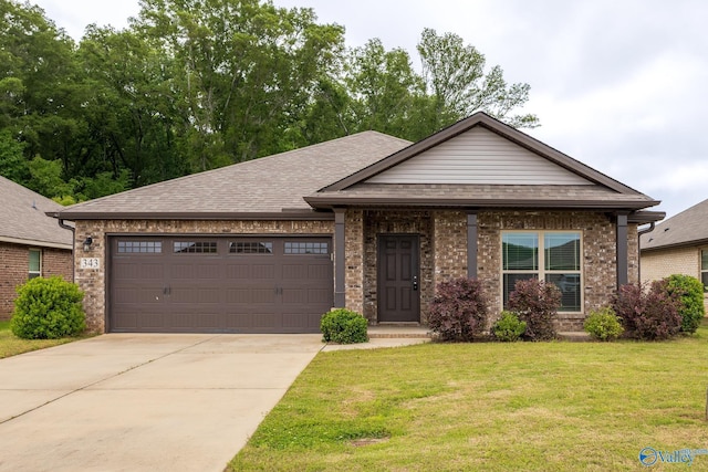 343 Willow Bank Cir, Decatur, AL 35603 - view of front of home with an attached garage, a front lawn, concrete driveway, brick siding, and roof with shingles