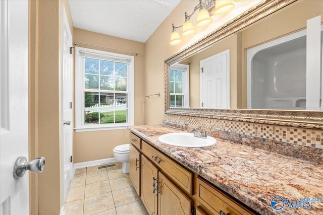 bathroom featuring tile patterned flooring, a textured ceiling, backsplash, vanity, and toilet