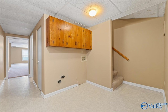 clothes washing area featuring hookup for a washing machine and cabinets