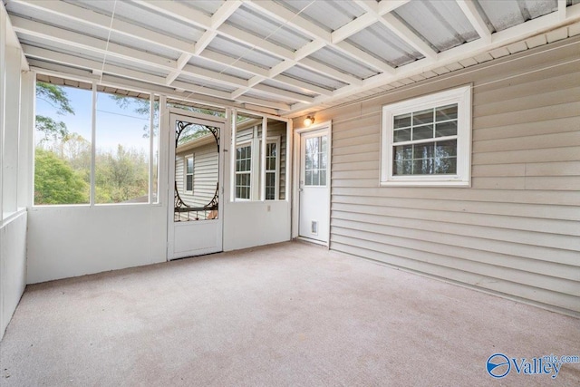 unfurnished sunroom featuring coffered ceiling and beamed ceiling