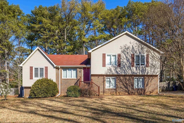 tri-level home with a front lawn