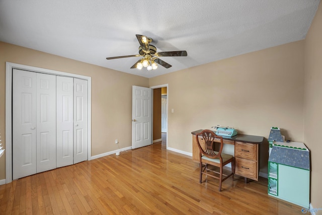 office with hardwood / wood-style floors, a textured ceiling, and ceiling fan