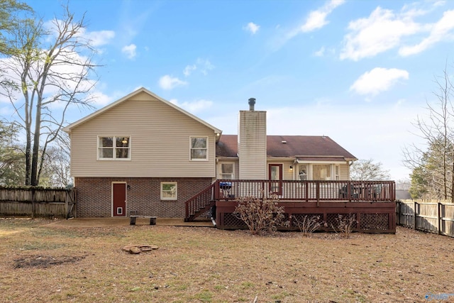 back of property featuring a yard and a deck