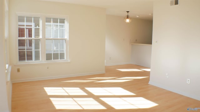 empty room with light hardwood / wood-style flooring