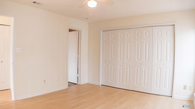 unfurnished bedroom with ceiling fan, a closet, and light hardwood / wood-style flooring