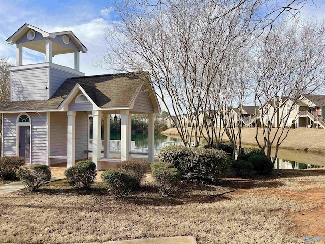 view of front of house with a water view