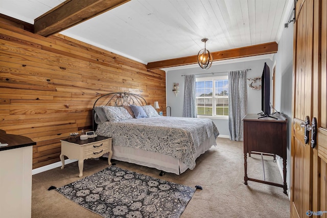 carpeted bedroom featuring wooden walls, beam ceiling, and wood ceiling