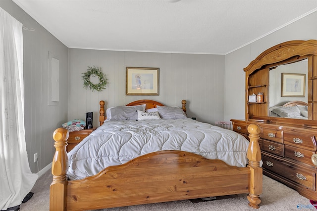 bedroom with carpet floors and crown molding