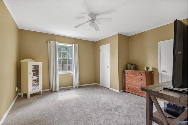 carpeted office space with visible vents, a ceiling fan, and baseboards