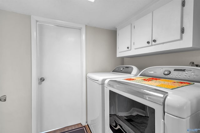 laundry room featuring washing machine and dryer and cabinet space