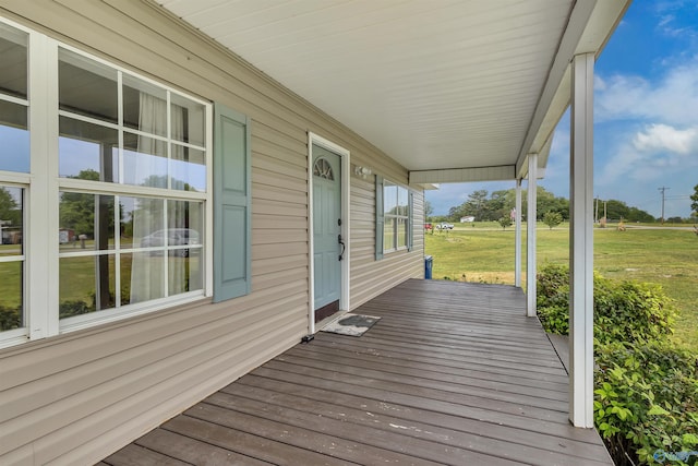 deck with a porch and a yard