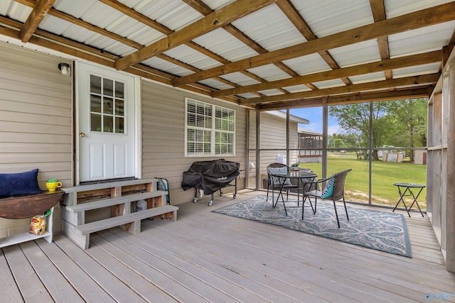 deck with a lawn, outdoor dining space, and area for grilling