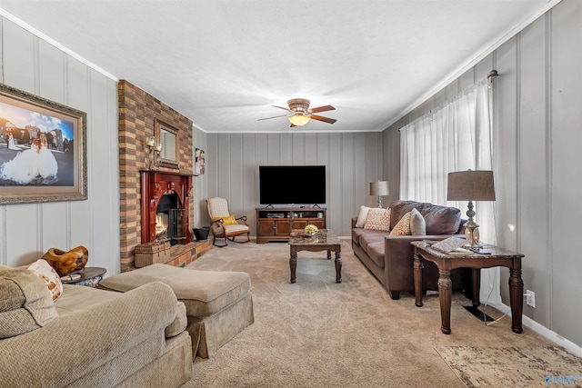 living room featuring light colored carpet, ceiling fan, a decorative wall, and ornamental molding