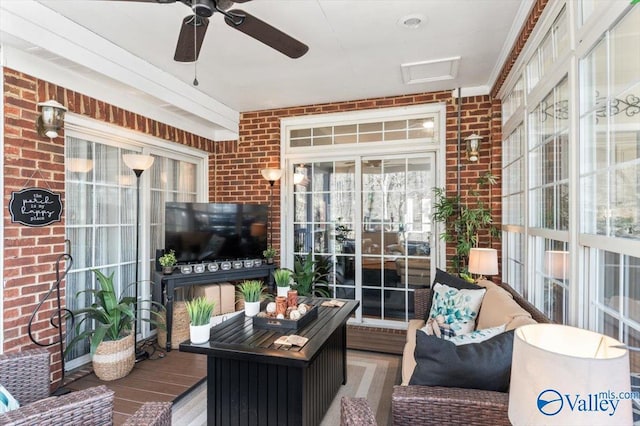 sunroom featuring ceiling fan