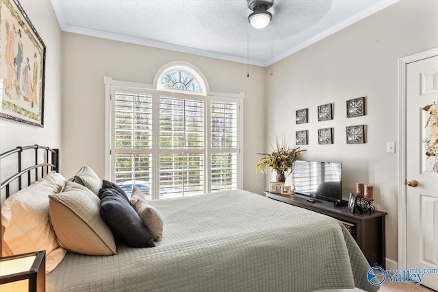 bedroom featuring a textured ceiling, ceiling fan, and crown molding