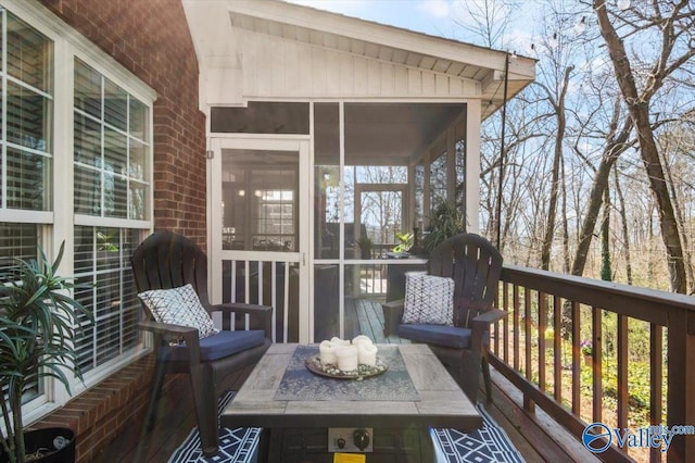 wooden deck featuring a sunroom