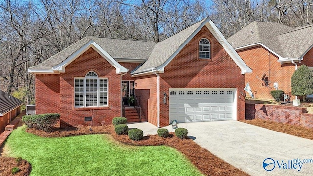 view of front of house featuring driveway, a shingled roof, a front lawn, crawl space, and brick siding