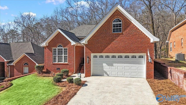 traditional home with a front yard, cooling unit, driveway, a shingled roof, and brick siding