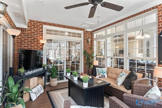 sunroom featuring ceiling fan