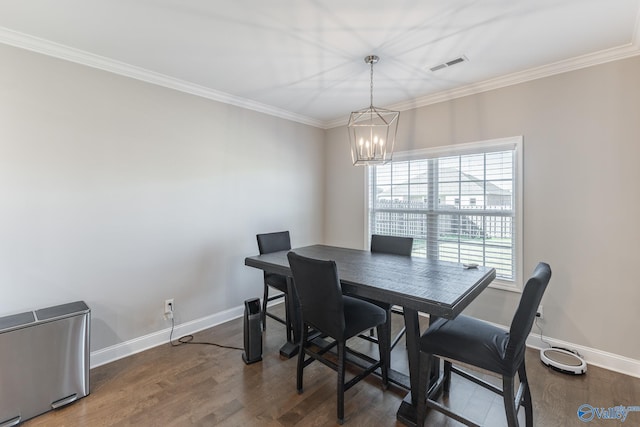 dining room featuring ornamental molding, an inviting chandelier, and dark wood-type flooring