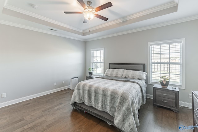 bedroom featuring a raised ceiling, ceiling fan, dark hardwood / wood-style flooring, and ornamental molding