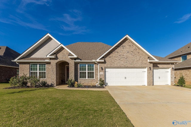 view of front of property with a garage and a front lawn