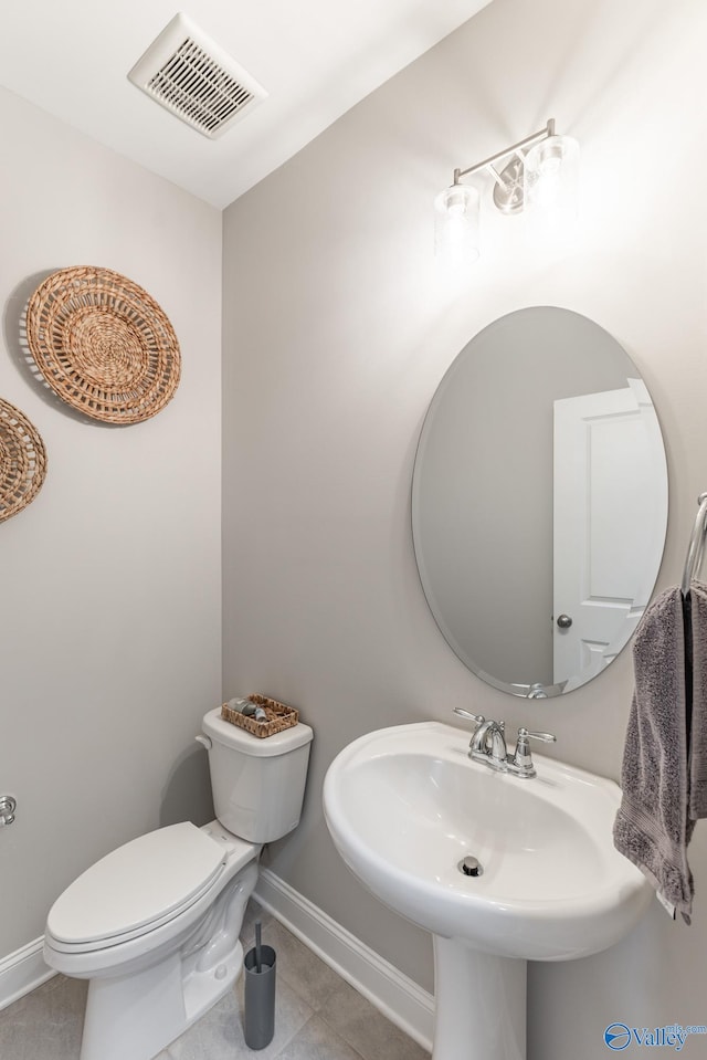 bathroom with tile patterned flooring, toilet, and sink