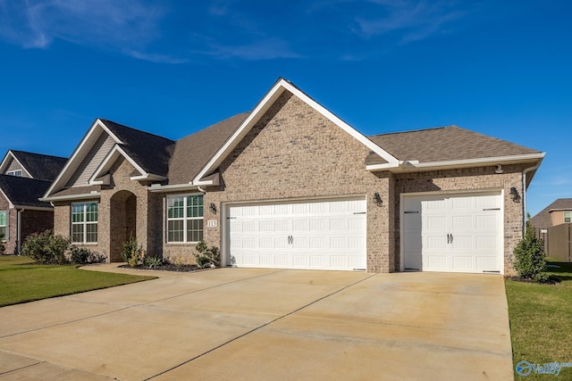 view of front of home with a garage and a front yard