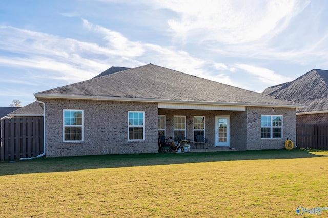 rear view of property with a yard