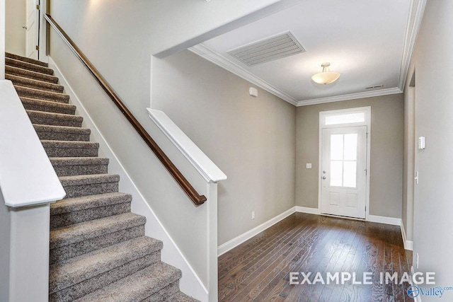 foyer with dark hardwood / wood-style flooring and ornamental molding