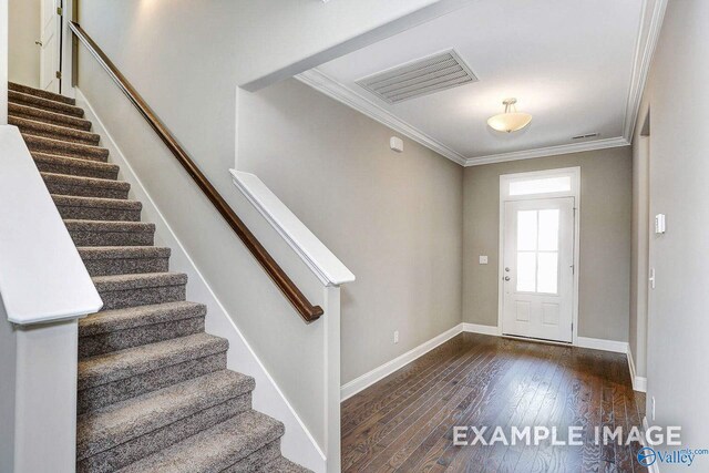 corridor featuring dark wood-type flooring and ornamental molding