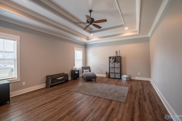 25366 Nettlebrooke Dr, Athens, AL 35613 - living area featuring dark wood finished floors, a raised ceiling, a ceiling fan, ornamental molding, and baseboards