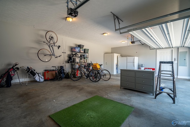 25366 Nettlebrooke Dr, Athens, AL 35613 - garage with a garage door opener, electric panel, and freestanding refrigerator
