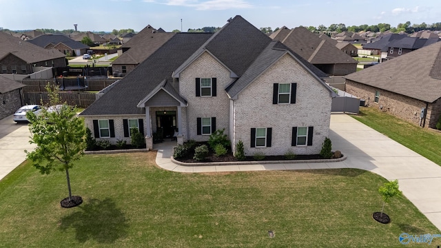25366 Nettlebrooke Dr, Athens, AL 35613 - view of front of house featuring brick siding, a front yard, a residential view, and concrete driveway