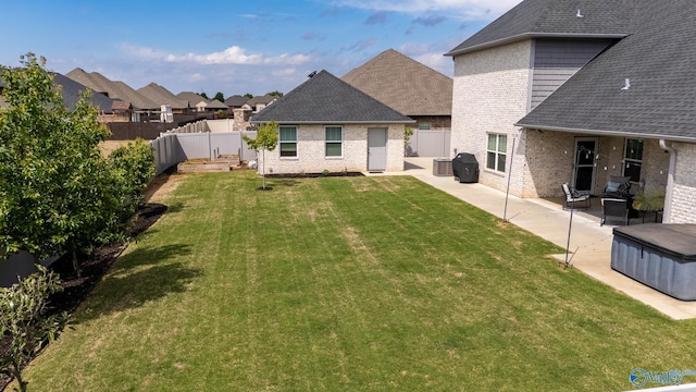 25366 Nettlebrooke Dr, Athens, AL 35613 - back of house featuring a yard, a patio area, roof with shingles, and a fenced backyard