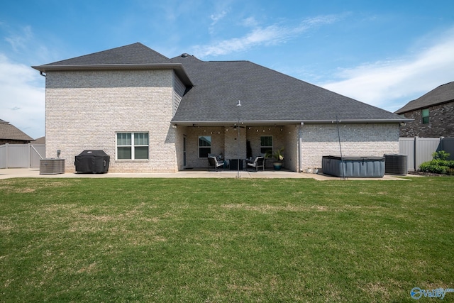 25366 Nettlebrooke Dr, Athens, AL 35613 - rear view of property featuring brick siding, fence, a hot tub, and a patio