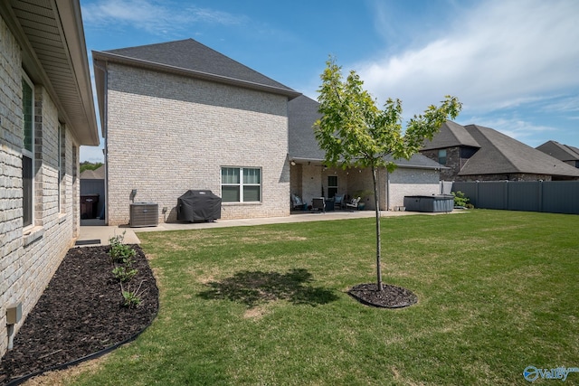 25366 Nettlebrooke Dr, Athens, AL 35613 - back of property featuring brick siding, central AC, a hot tub, and a patio
