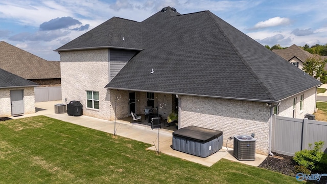 25366 Nettlebrooke Dr, Athens, AL 35613 - rear view of property featuring a fenced backyard, central air condition unit, a patio, a lawn, and brick siding
