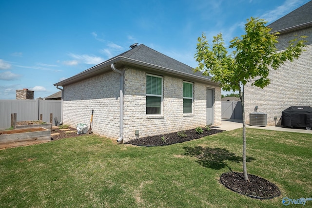 25366 Nettlebrooke Dr, Athens, AL 35613 - view of property exterior featuring a garden, a gate, central air condition unit, fence, and a yard
