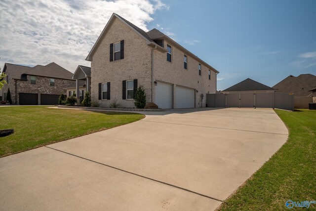 25366 Nettlebrooke Dr, Athens, AL 35613 - exterior space with a lawn, driveway, a gate, and a garage