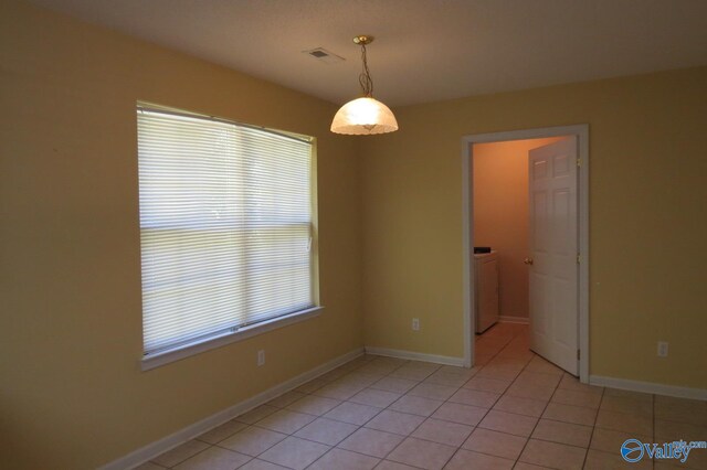 tiled spare room with washer / clothes dryer